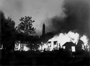 Against the backdrop of the Washington Monument, flames consume the BEF camp and its former occupant's belongings. 