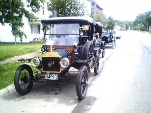 A line of Model Ts line US 27 in front of the Levi Coffin House, a popular destination for owners during the 2008 centennial.