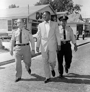 Dr. Gilbert R. Mason, Sr. is led to the courthouse by Biloxi police officers 